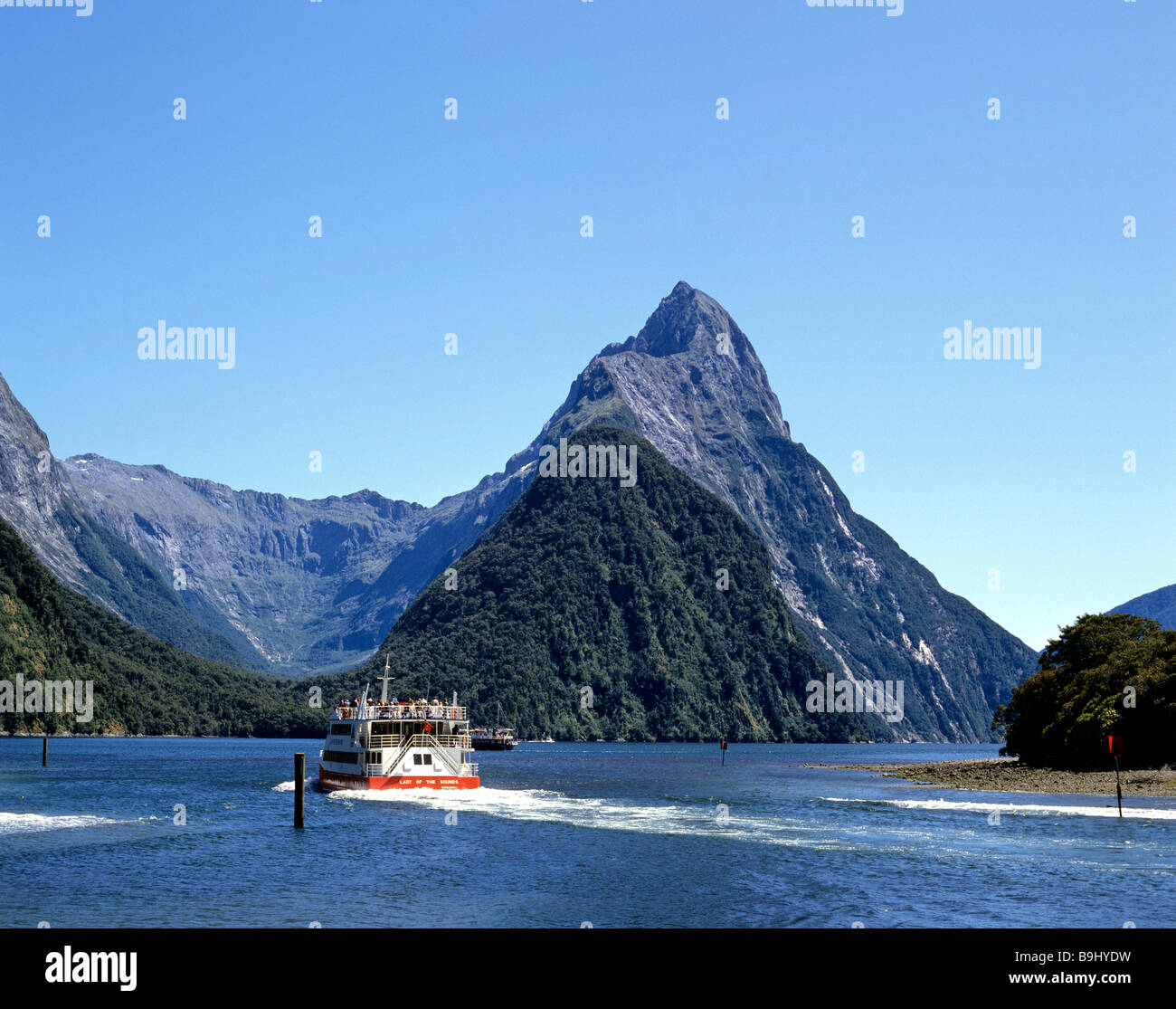 View of Mitre Peak, Milford Sound, tour boat, Fiordland National Park, South Island, New Zealand Stock Photo