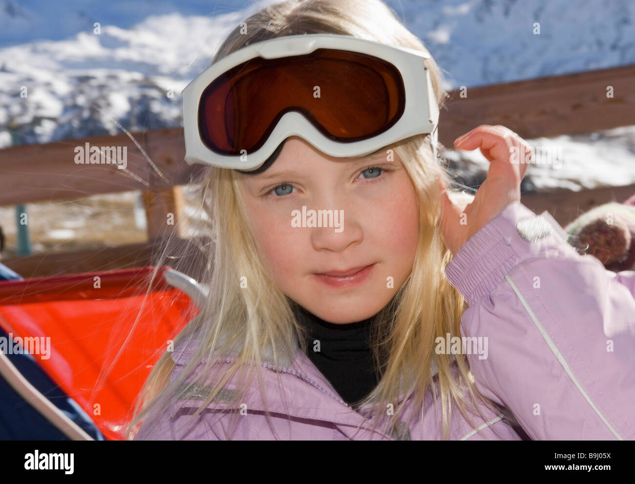 Girl looking to camera wearing goggles Stock Photo - Alamy
