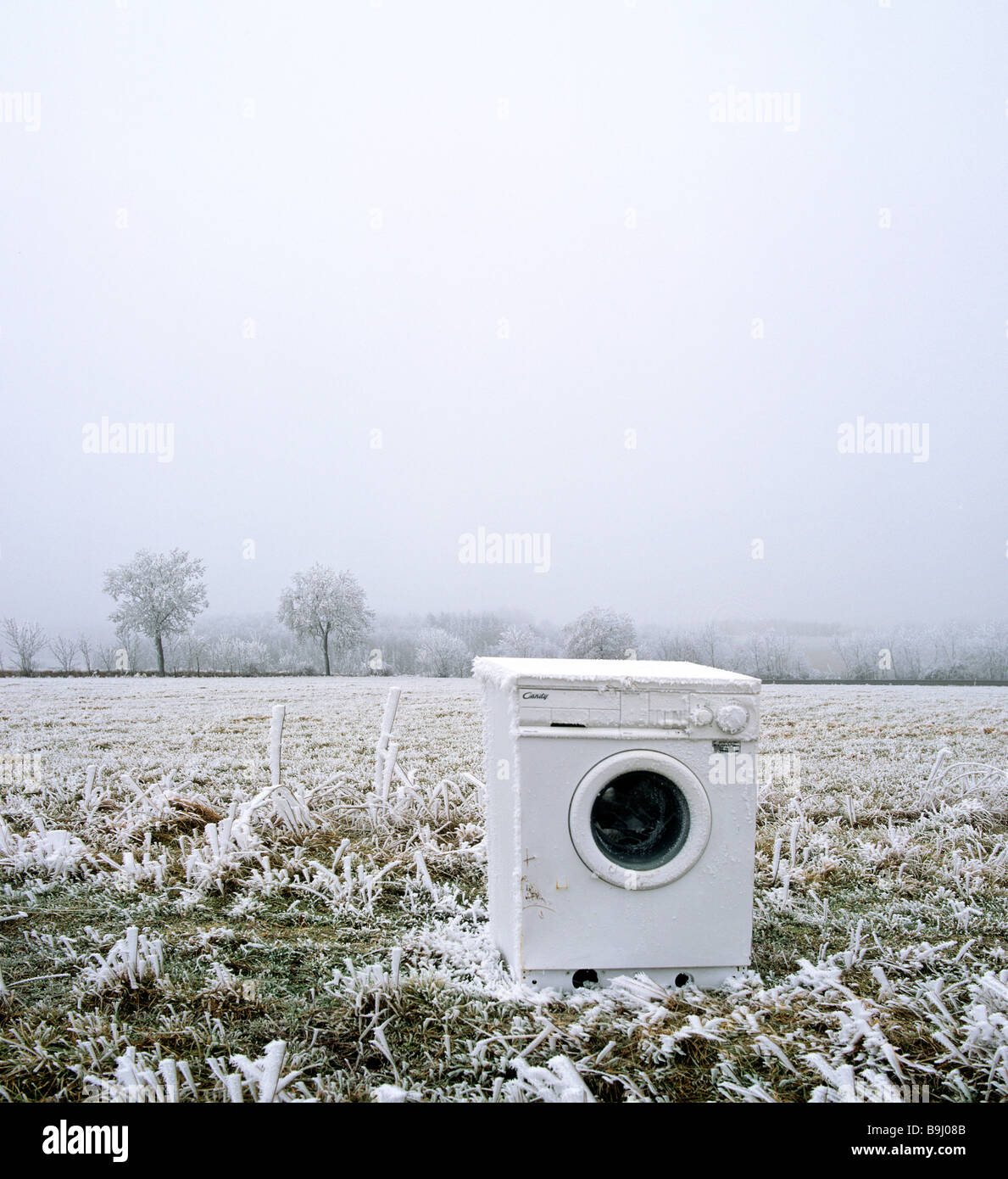 Old washing machine on a field, illegal waste disposal, Germany Stock Photo