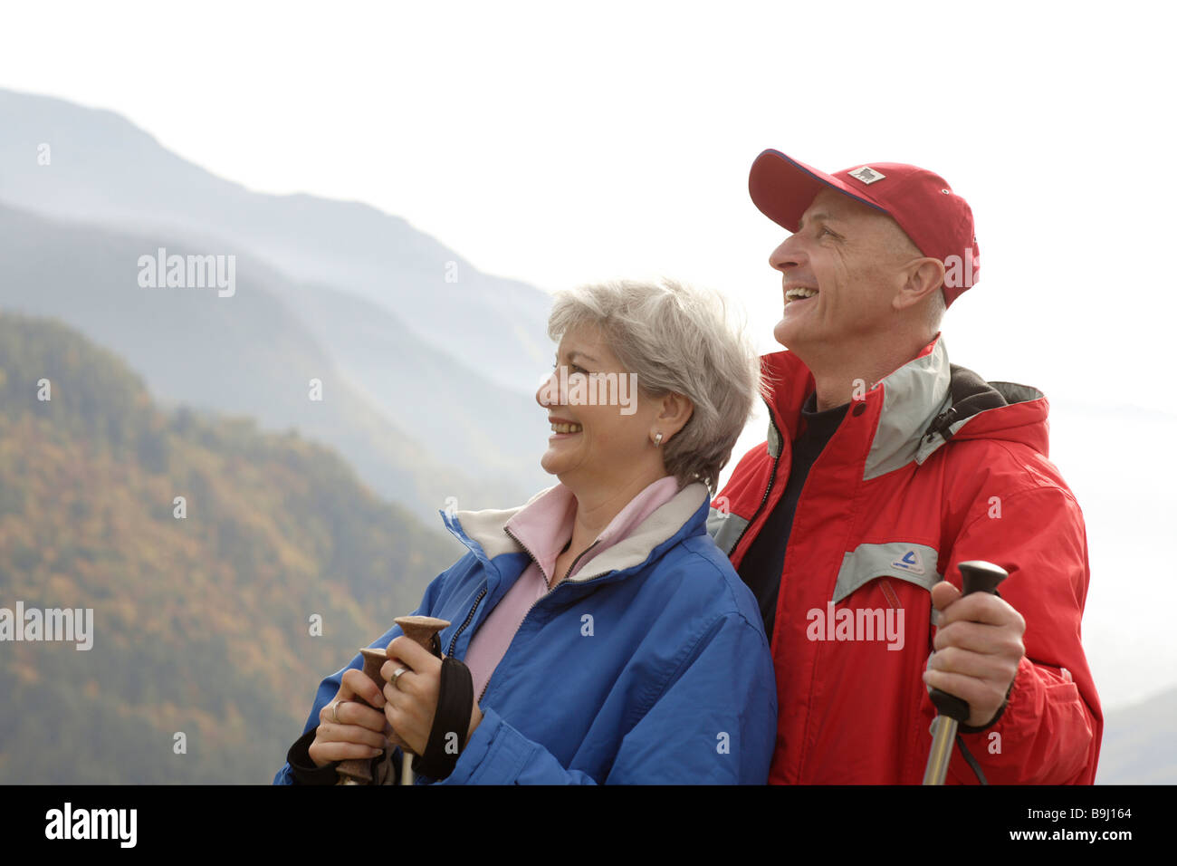 Old-aged couple taking a break from Nordic walking Stock Photo
