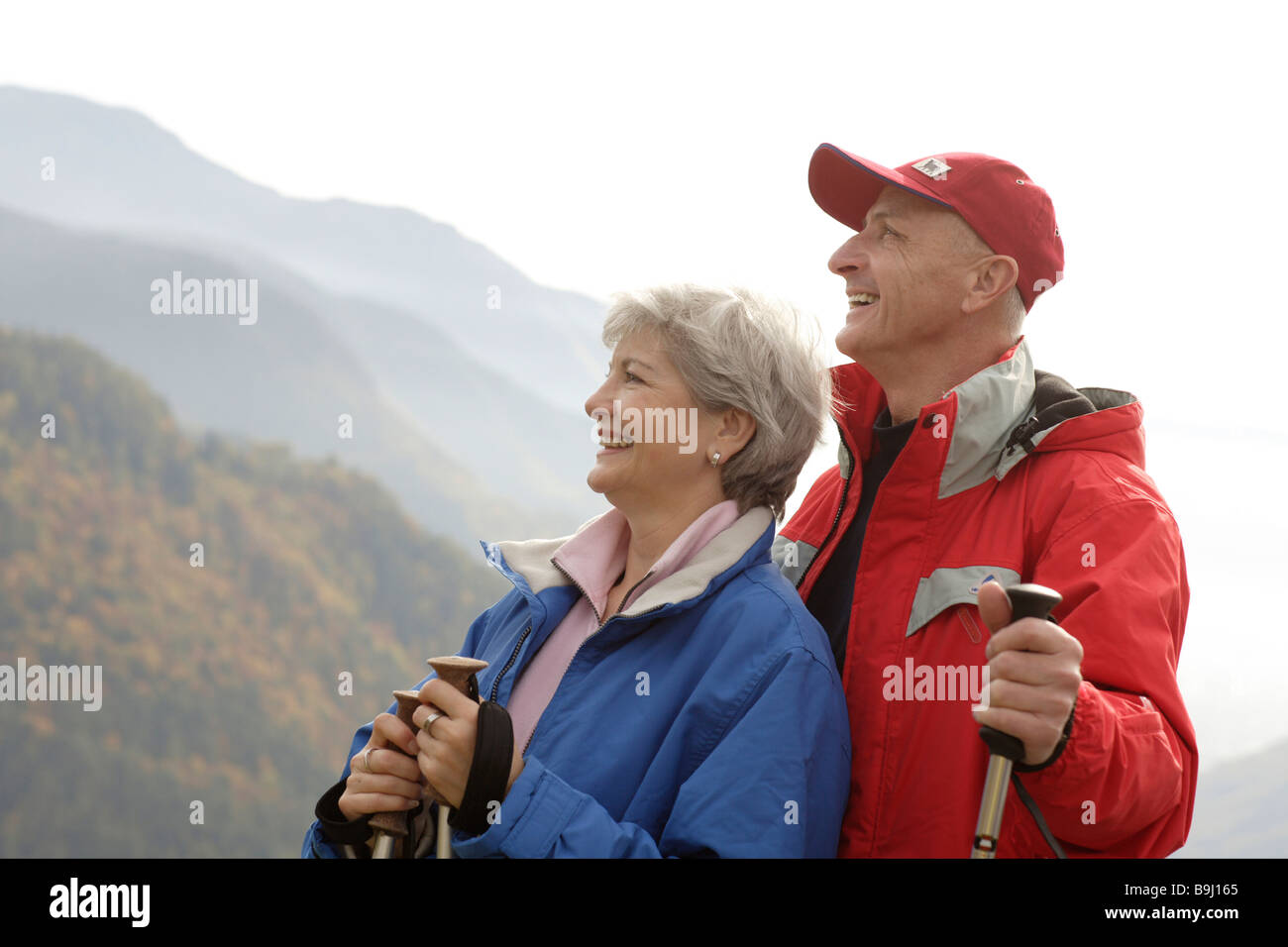 Old-aged couple taking a break from Nordic walking Stock Photo