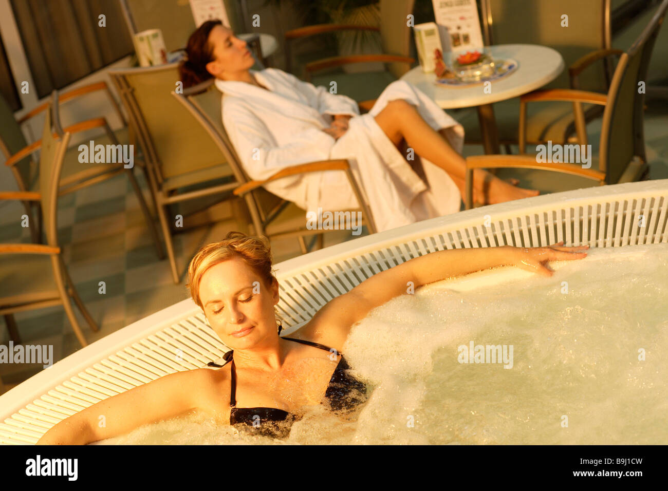Whirlpool, two young women relaxing Stock Photo