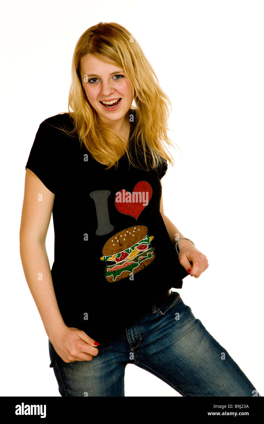 Thin 13-year-old girl wearing a t-shirt with a picture of a hamburger, laughing challengingly Stock Photo