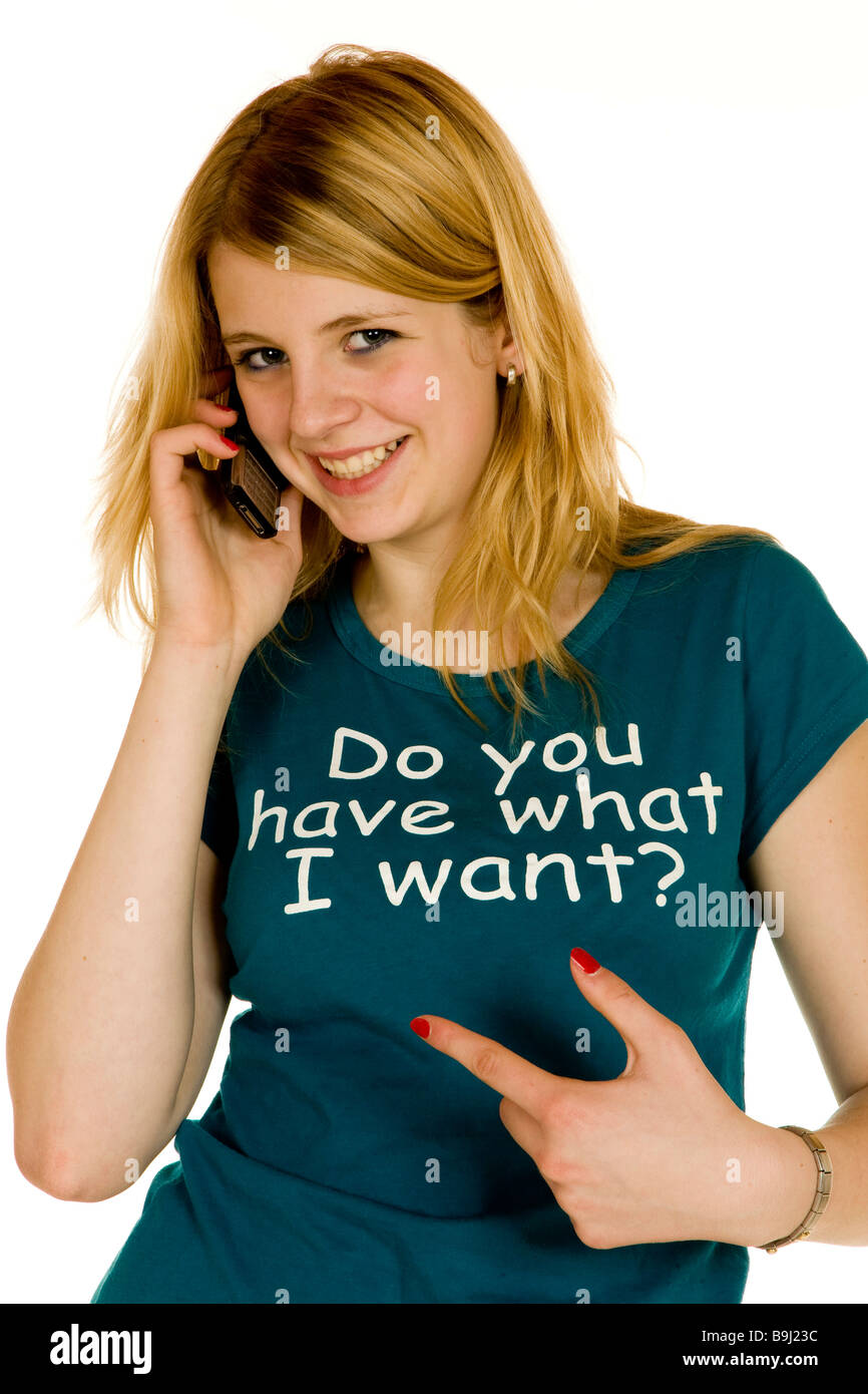13-year-old girl on the phone, wearing a t-shirt, 'Do you have what I want?' written on it Stock Photo