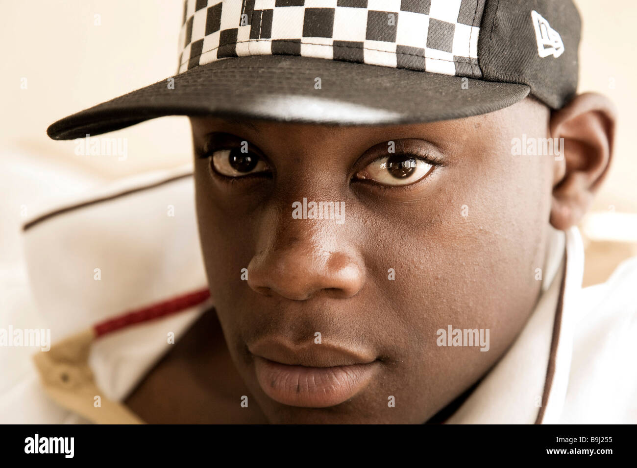Dark-skinned, 15-year-old boy, wearing a baseball cap Stock Photo