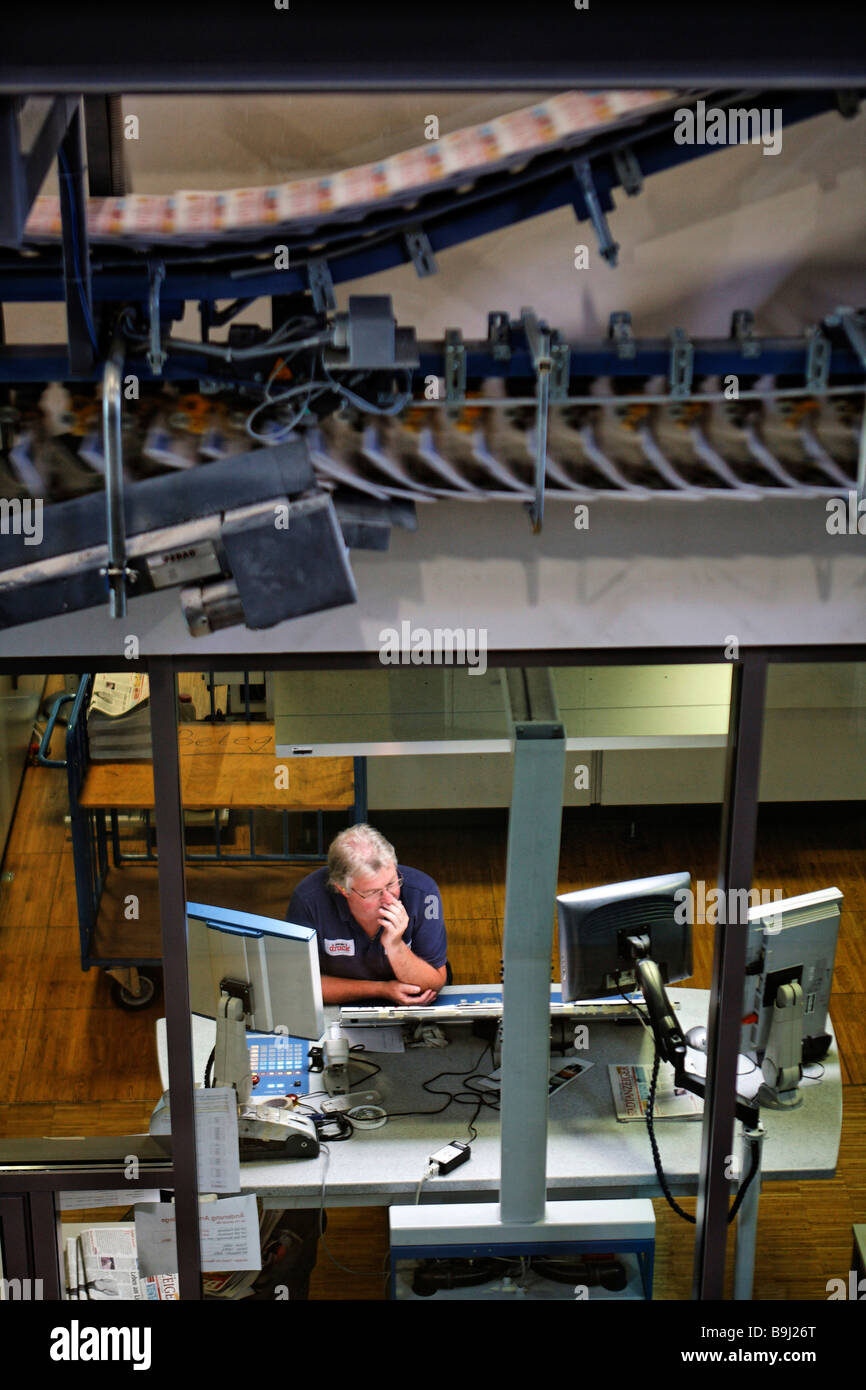 Print employee controlling print at control station, above him a
