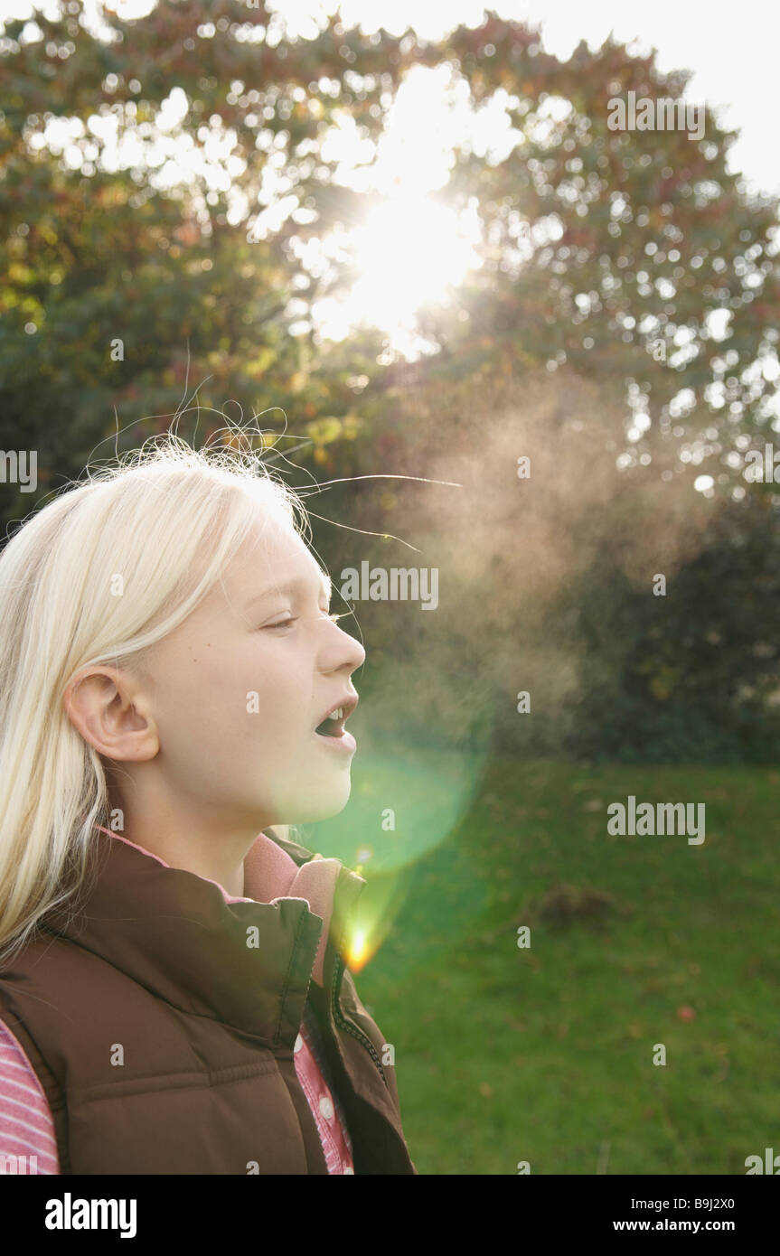 Girl breathing into cold air Stock Photo