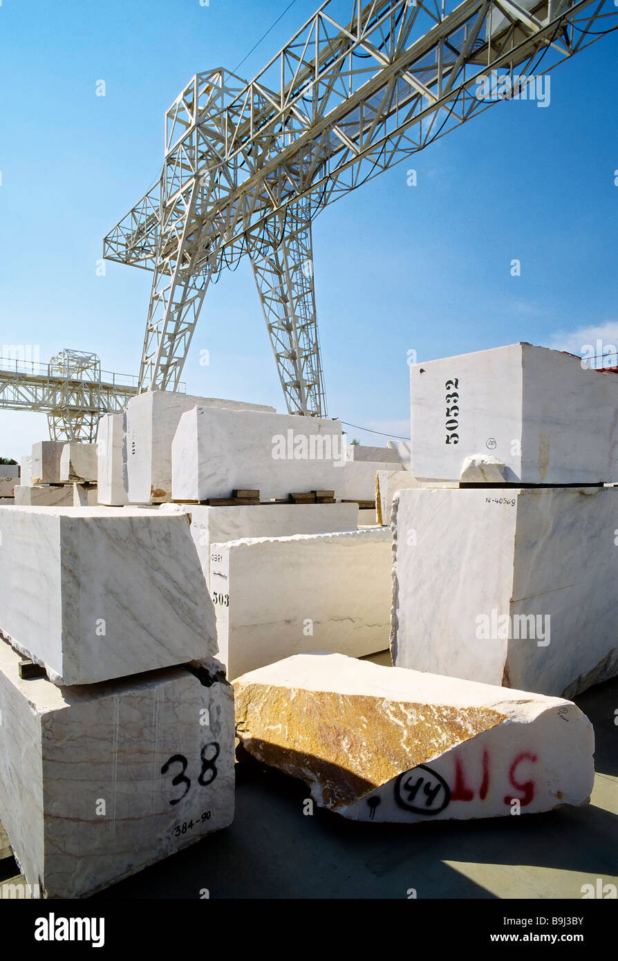 Large marble blocks, Statuario, stacked under a crane awaiting delivery, Carrara, Versilia, Tuscany, Italy, Europe Stock Photo