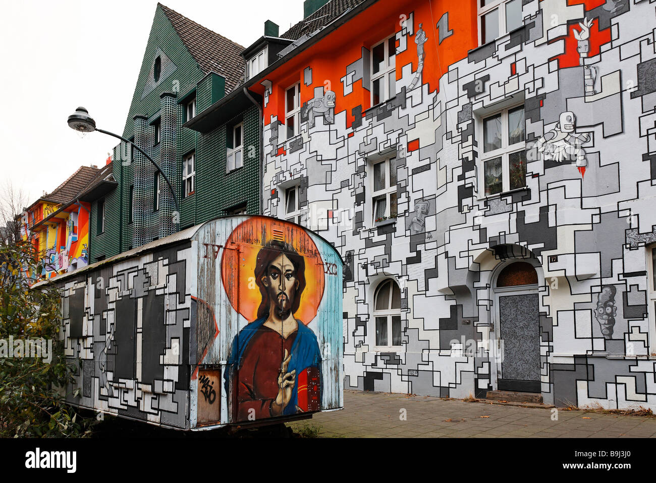 Multicolored painted house facades, builders trailer with Jesus ...