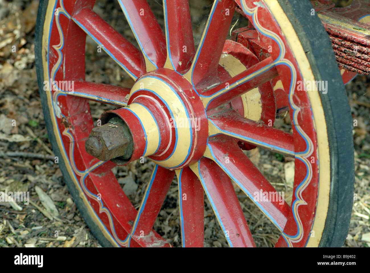 Red, yellow and blue painted and decorated wooden cart wheel decorated
