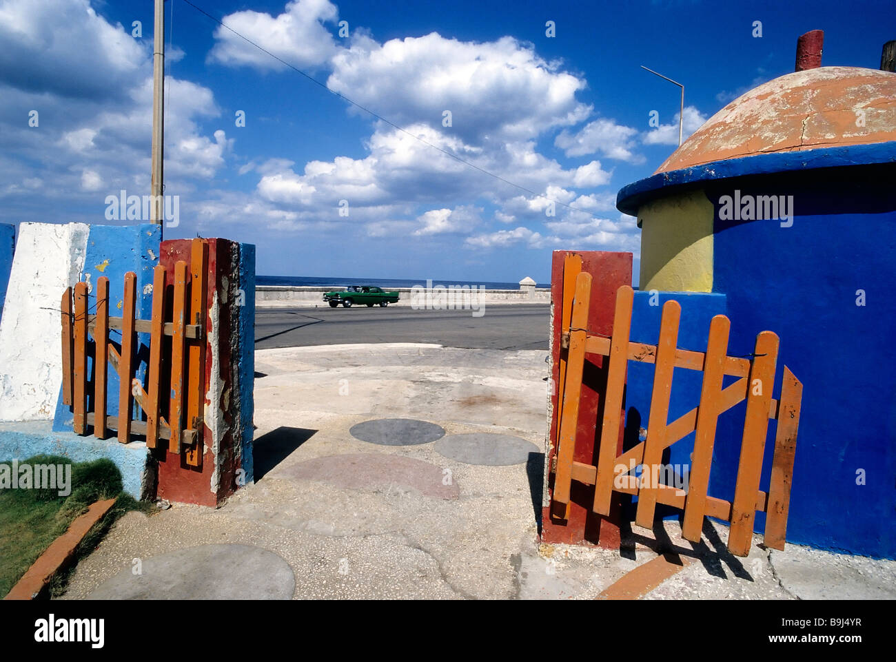 View of the coast road, from the entrance of a playground, coloured wooden fence, Malecon, Havana, Cuba, Caribbean Stock Photo