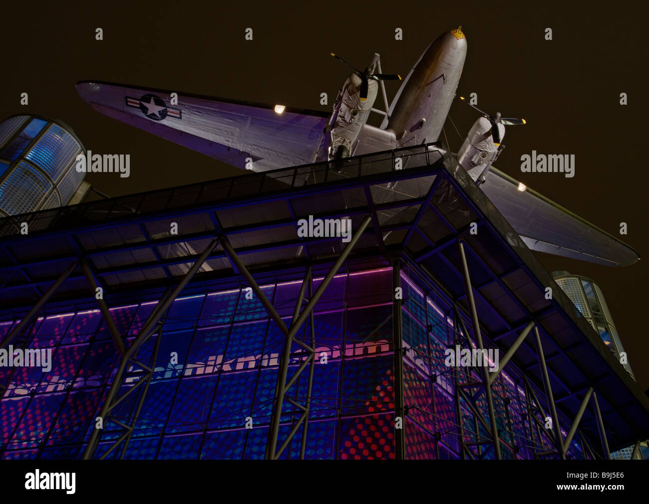 Night shot of the front of the German Technology Museuem, Deutsches Technik Museum, with Raisin Bomber or Candy Bomber on the r Stock Photo