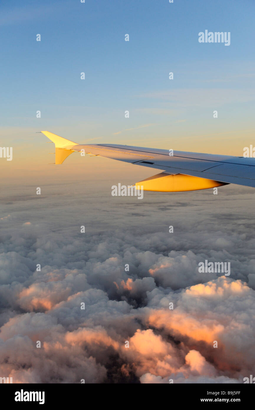 Wings, plane, Lufthansa Airbus A340-313X, above the clouds at sunrise Stock Photo