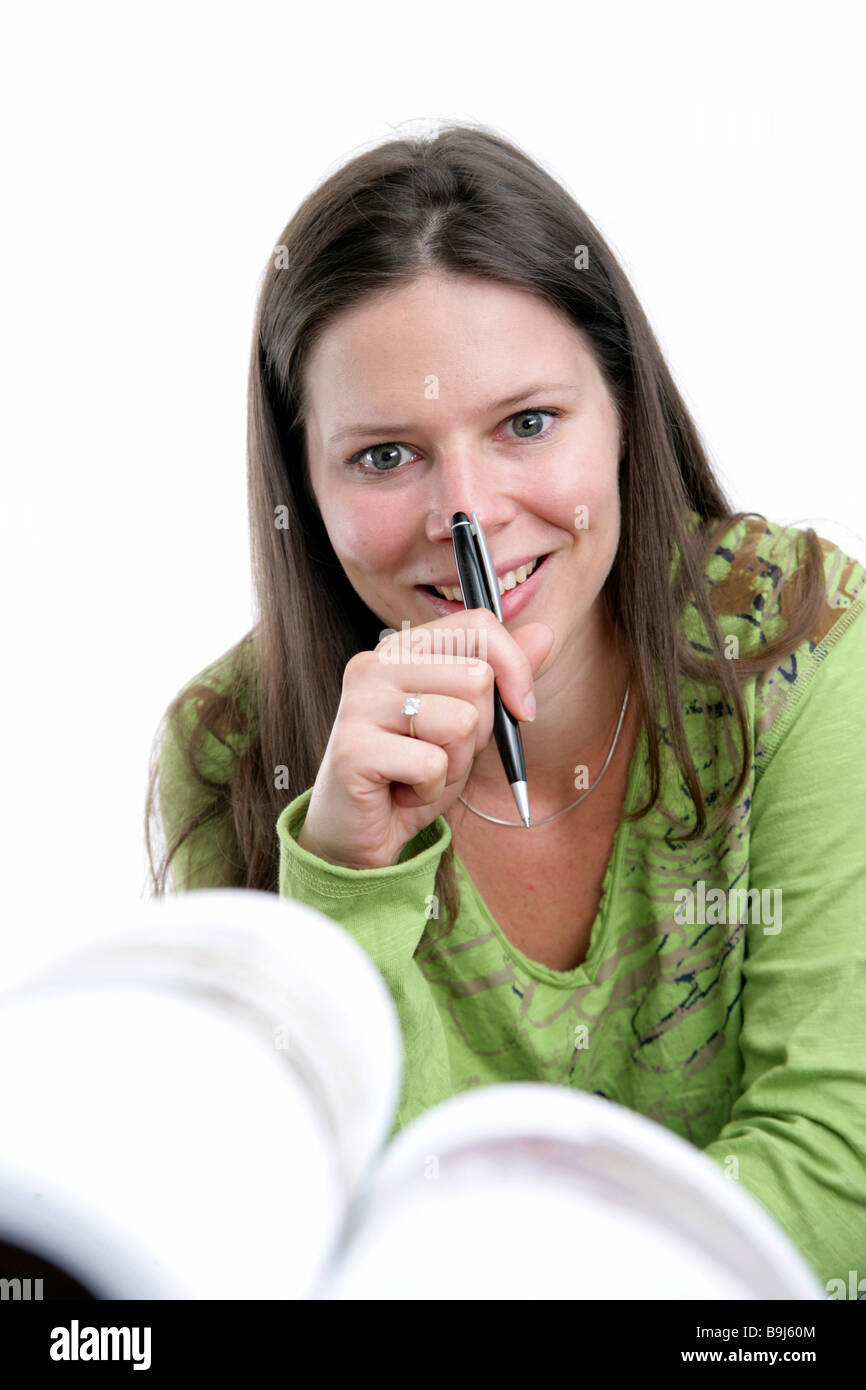 Young girl with a book, holding a pen Stock Photo - Alamy
