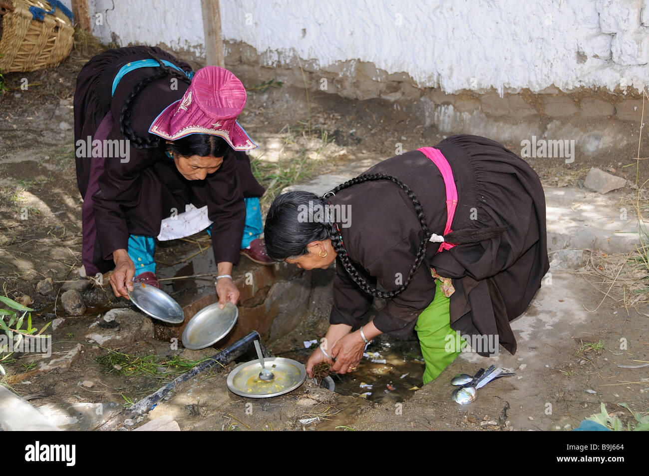 Ladakhi women in traditional costume washing up, Leh, Ladakh, North India, Himalaya, Asia Stock Photo