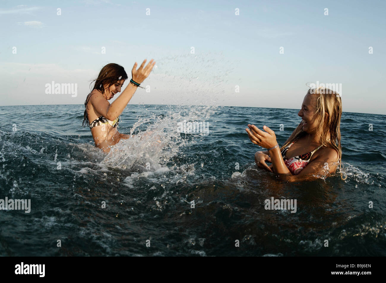 Girls teenagers playing in the sea Stock Photo