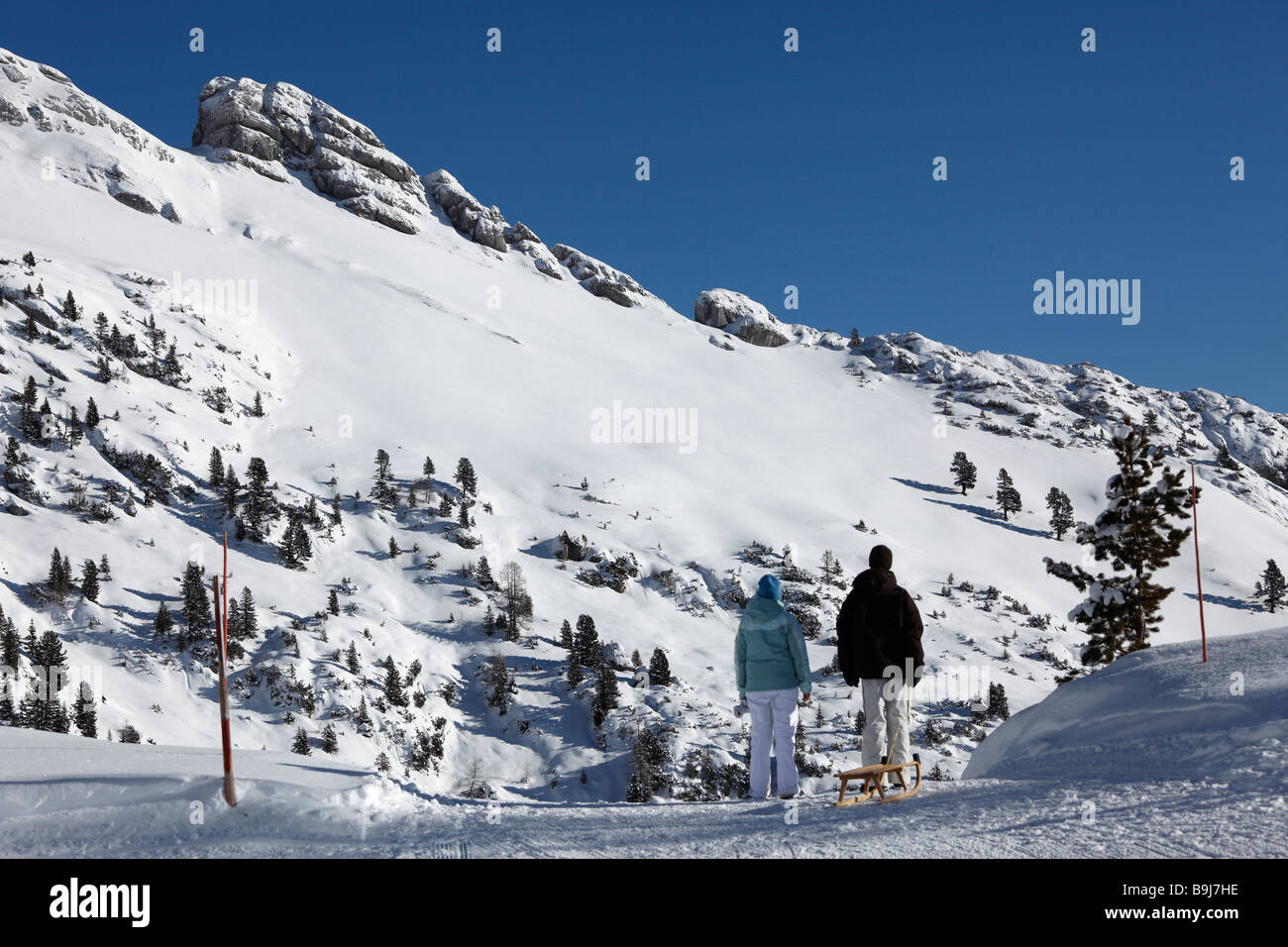 Couple pulling a sledge in front of Mt Haiderjoch in the Rofan, Rofan Range, Tyrol, Austria, Europe Stock Photo