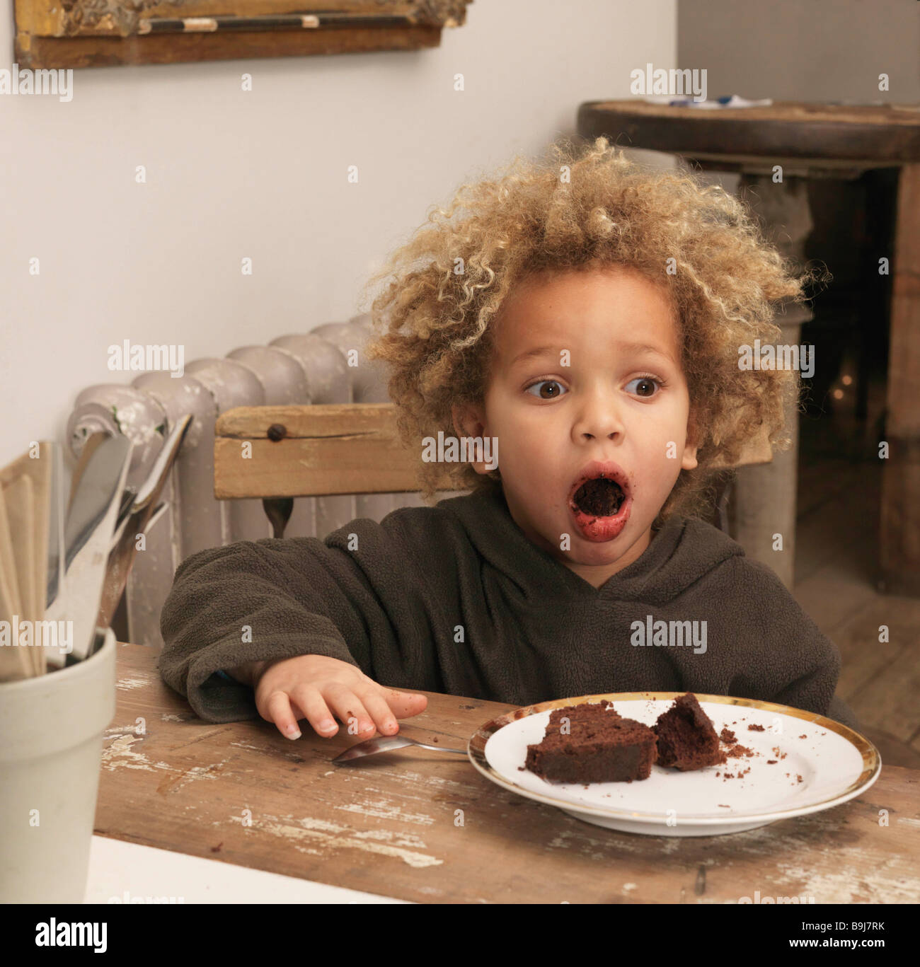 Young boy eating chocolate cake Stock Photo Alamy