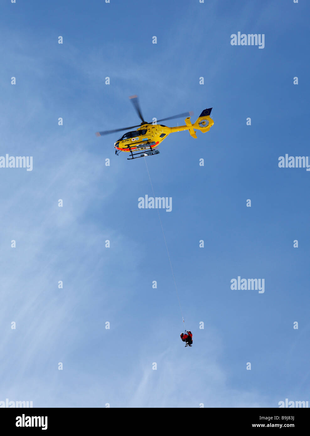 Rescue helicopter transporting injured people, on duty, Tyrol, Austria Stock Photo