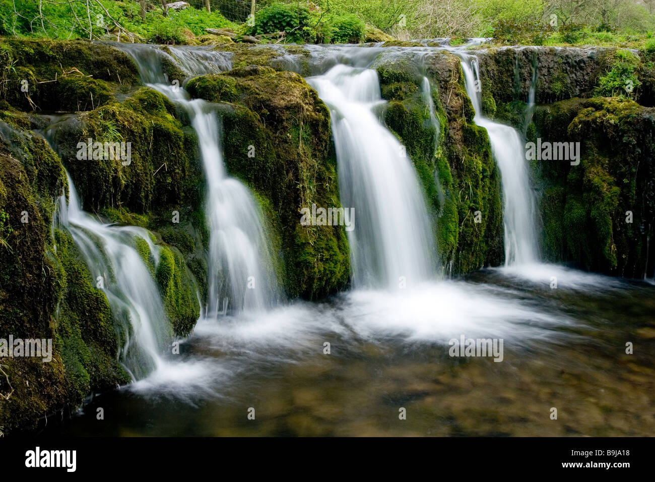 Small waterfalls in the Lathkill Dale National Nature Reserve in the Peak District National Park, Derbyshire Stock Photo