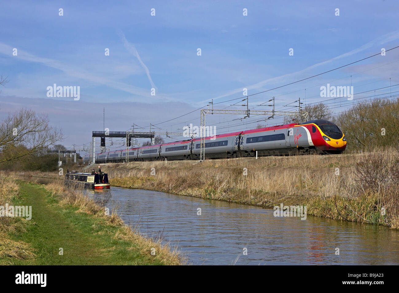 Virgin Pendolino passes the Oxford Canal at Ansty Rugby with a Glasgow Euston service on 11 03 09 Stock Photo