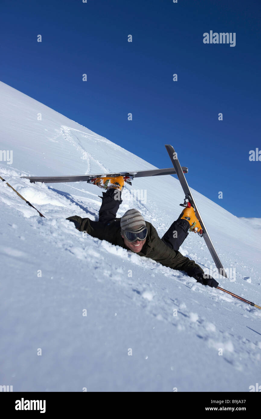 Male skier fallen over Stock Photo