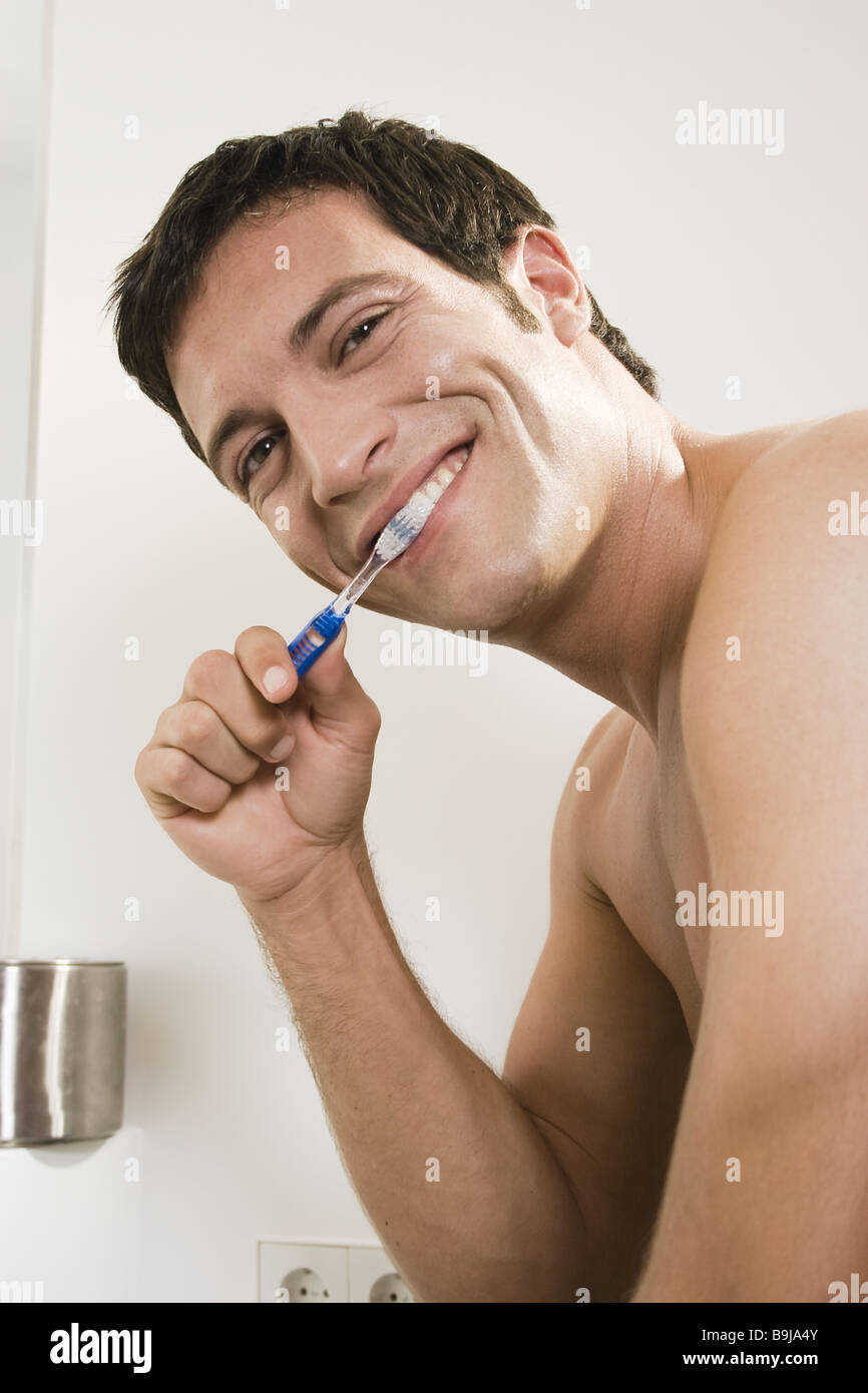 Man attractively teeth cleaning topless portrait 20-30 years 30-40 years of  evening daily attractively bath bathrooms beauty Stock Photo - Alamy