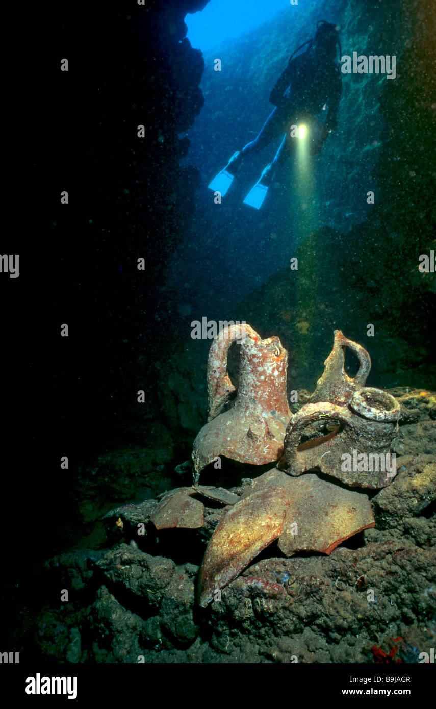 Scuba diver in an underwater cave with amphoras, Mediterranean Sea, Turkey Stock Photo