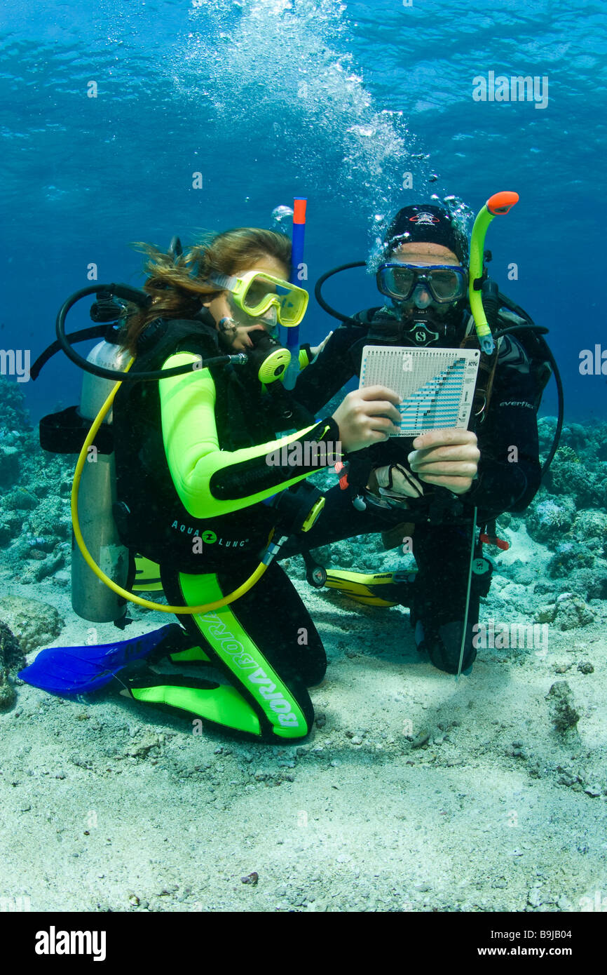 Scuba diving teacher with a child doing the diver's quaification in the