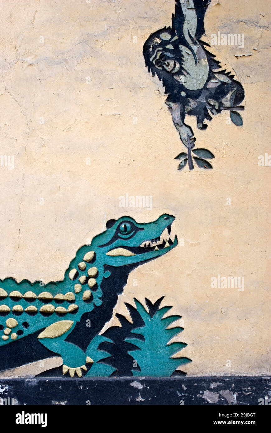 Artwork on the wall of an animal house in the Old Zoo (Stare Zoo) depicting a crocodile and a monkey, Poznan, Poland Stock Photo