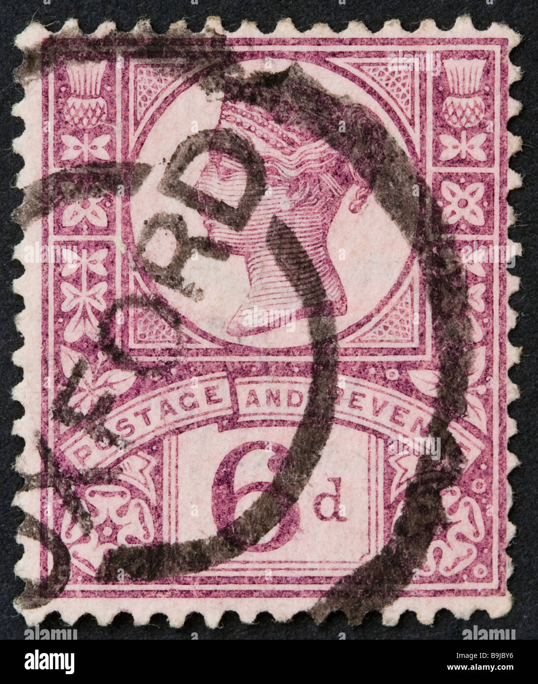 Close up of British Victorian 6d postage stamp on black background. SG