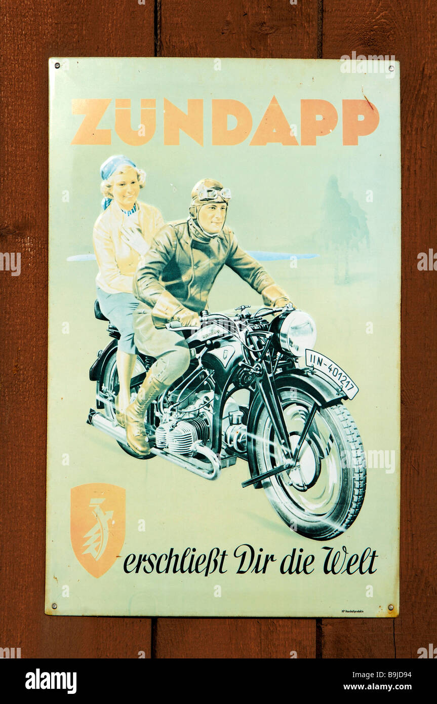 Old motorbike advertisement on a tin sign, on a wooden gate, Wichsenstein, Upper Franconia, Bavaria, Germany, Europe Stock Photo