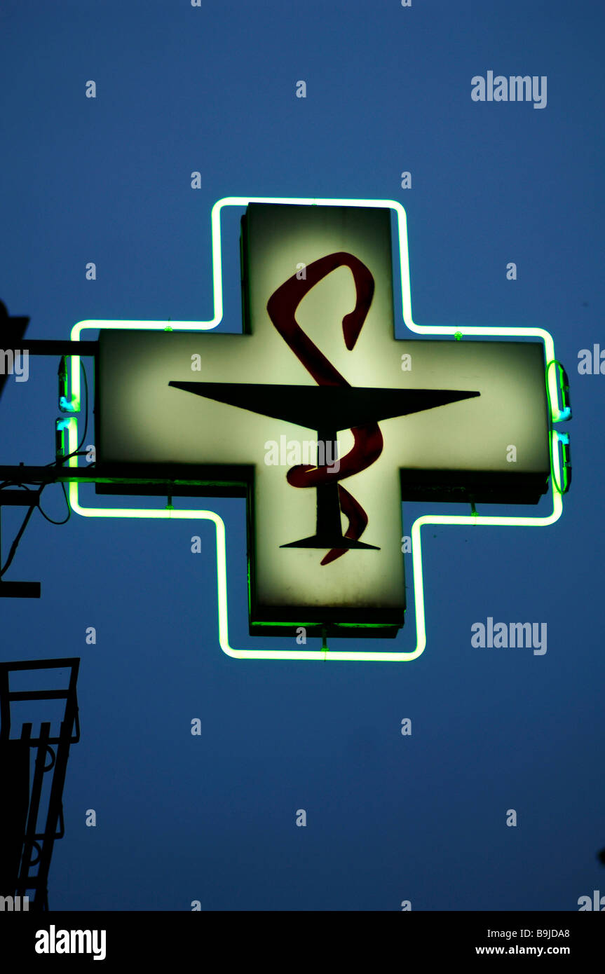 Illuminated pharmacy sign against evening sky, Ribeauvillé, Alsace, France, Europe Stock Photo