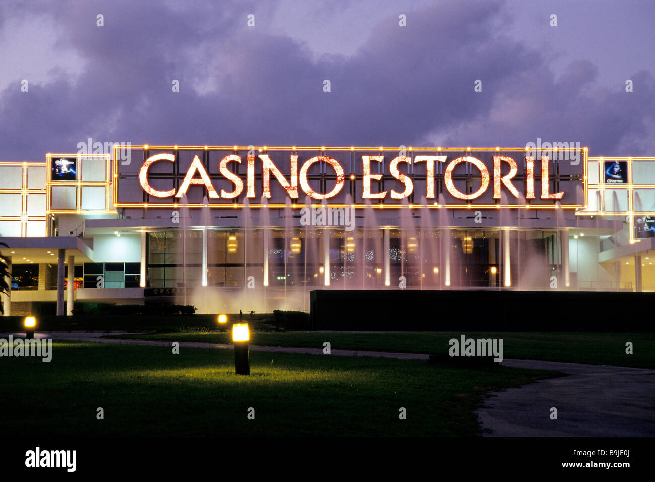 Estoril Casino in the evening, modern architecture, illuminated facade, spa gardens of Estoril, sophisticated sea resort, Lisbo Stock Photo