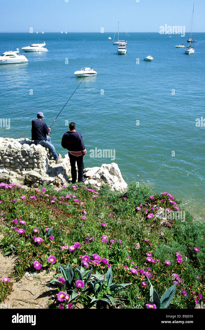 Praia da Rainha, fishermen on the rocky coast of Cascais, a seaside resort, grown together with Estoril, Lisbon, Portugal, Euro Stock Photo