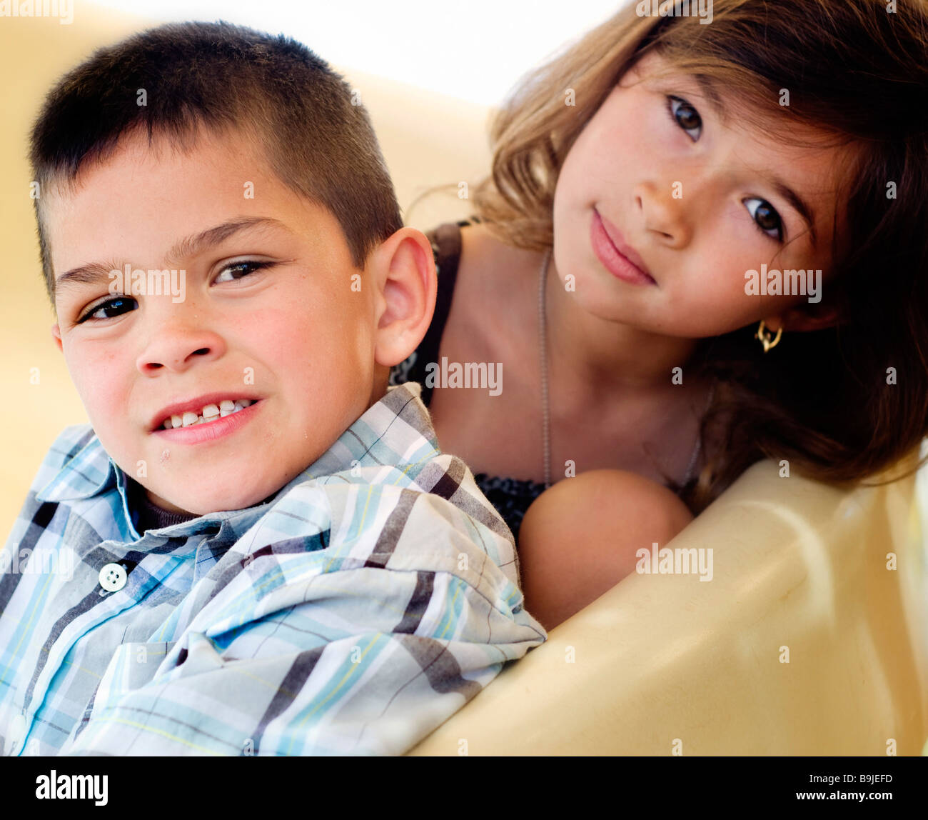 Brother and sister playing on slide in park Stock Photo - Alamy