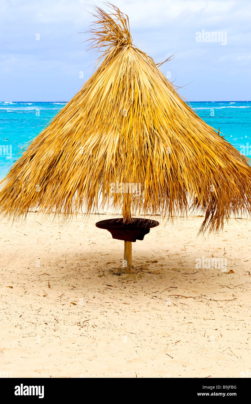 Grass umbrella on sandy Caribbean sea beach Stock Photo Alamy