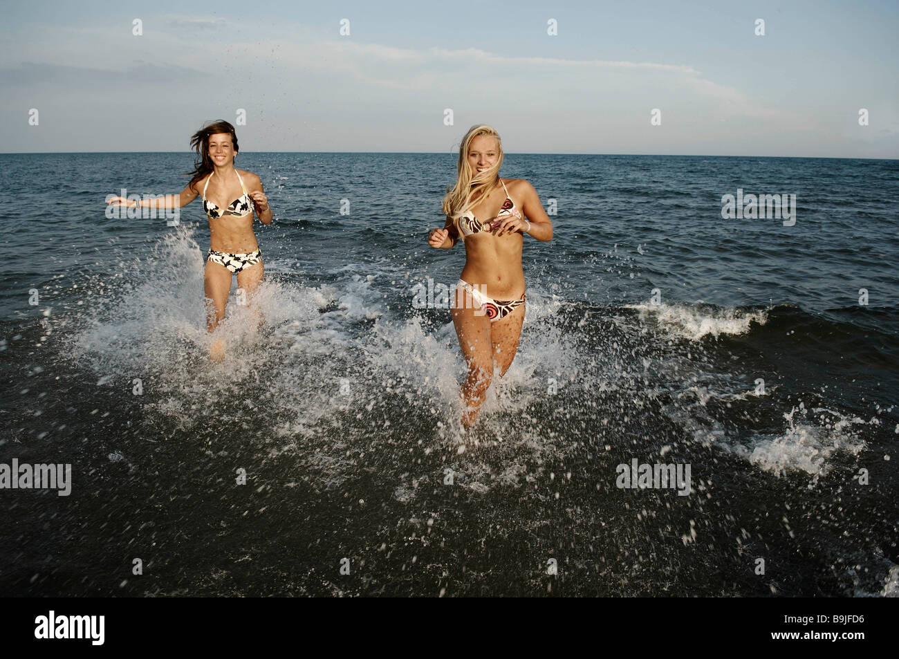 Girls teenagers playing in the sea Stock Photo