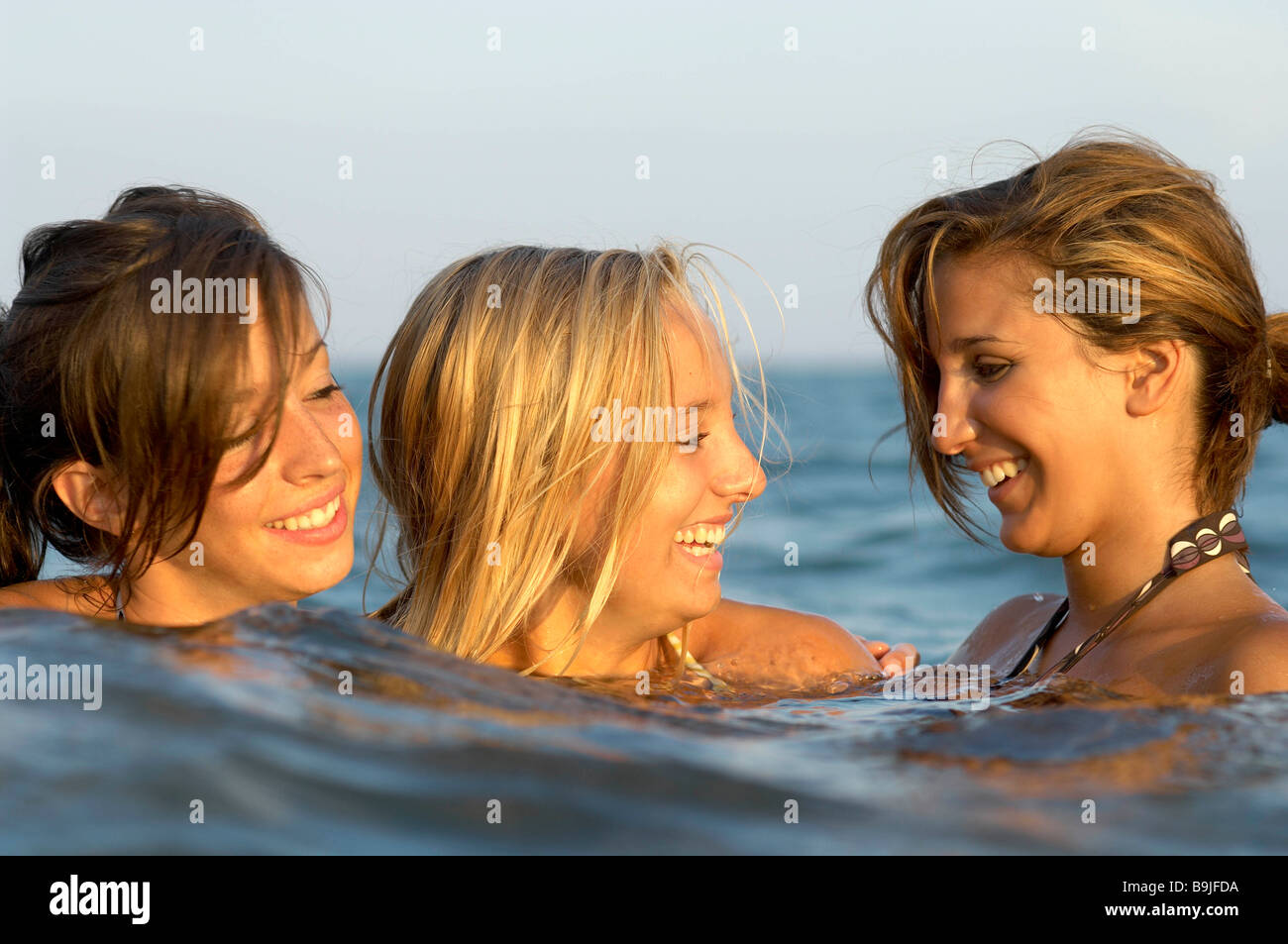 Girls teenagers playing in the sea Stock Photo