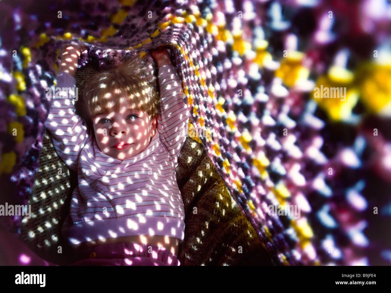 Child under blanket in sunlight Stock Photo Alamy