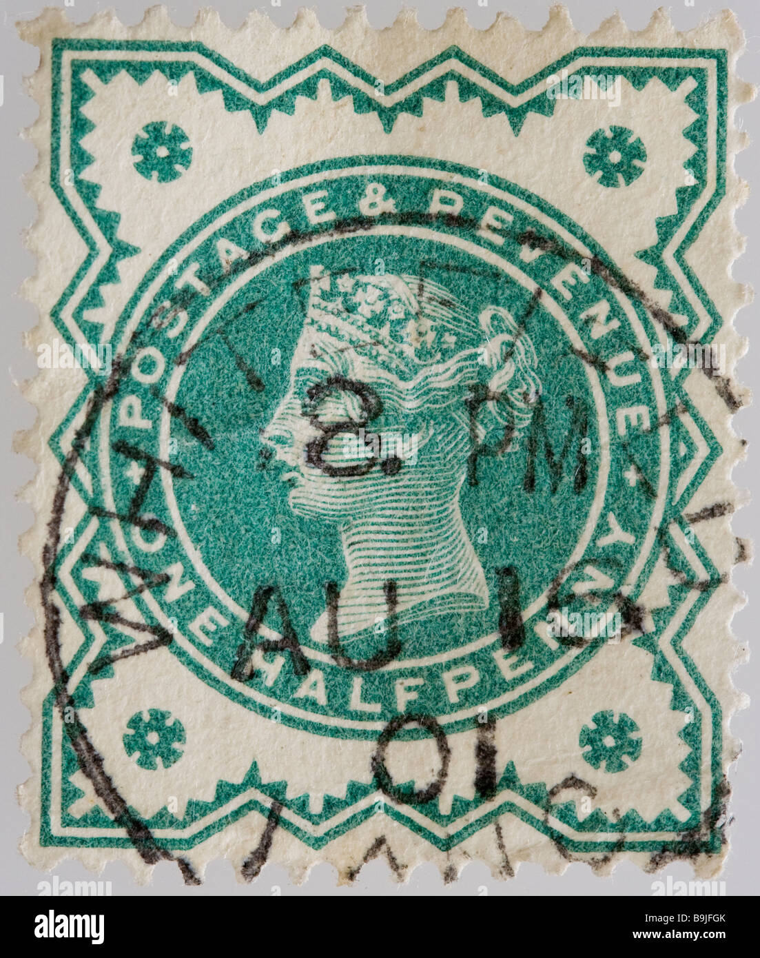 Close up of ½d, one half penny green Victorian British Postal stamp on black background issued between 1887-1900, part of the 'Jubilee Issue'. Used. Stock Photo