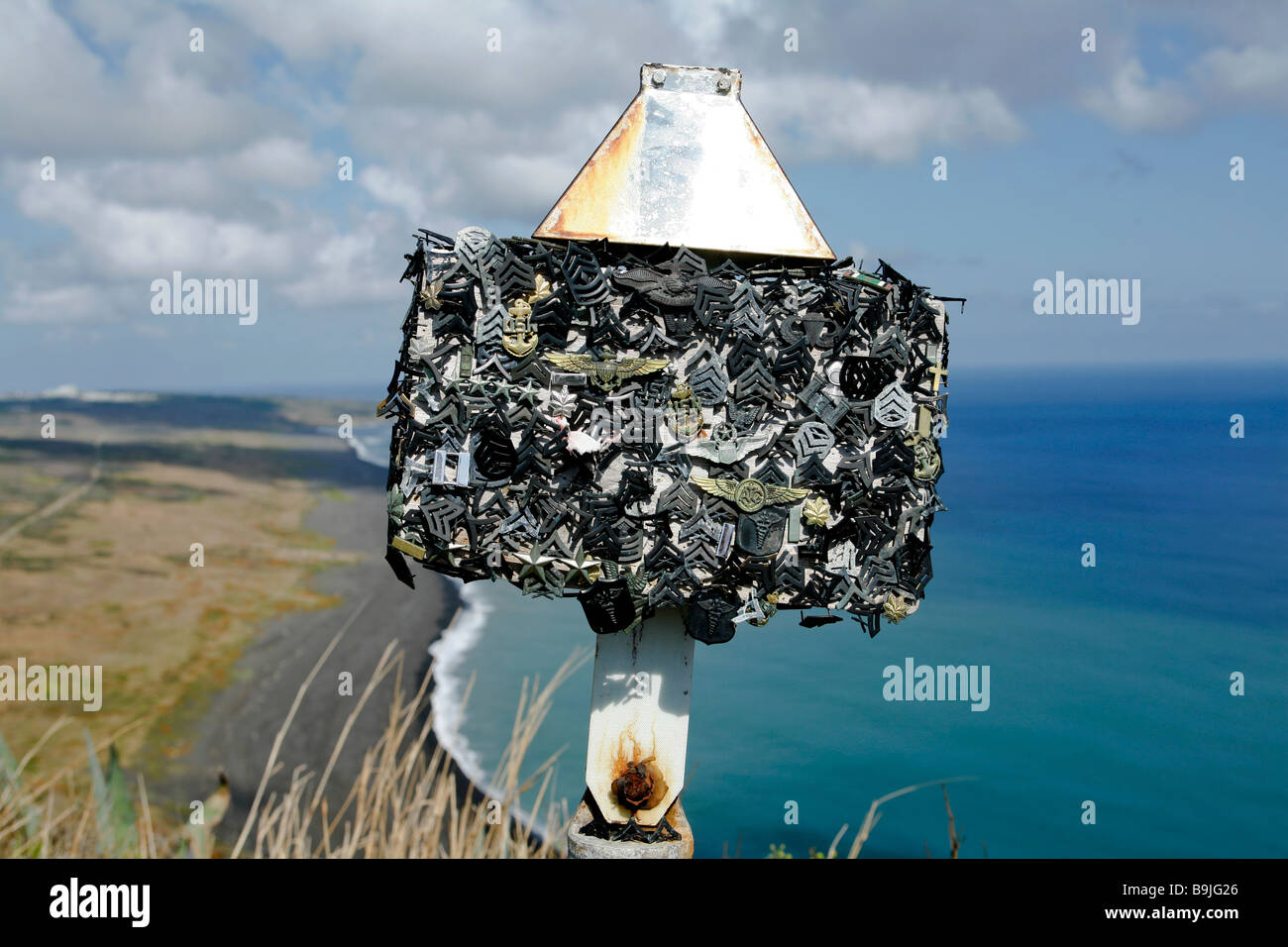 Memorial on Mt Suribachi Iwo Jima covered with dog tags and rank insignia  over looking the black sands of the Marine Corps invas Stock Photo - Alamy