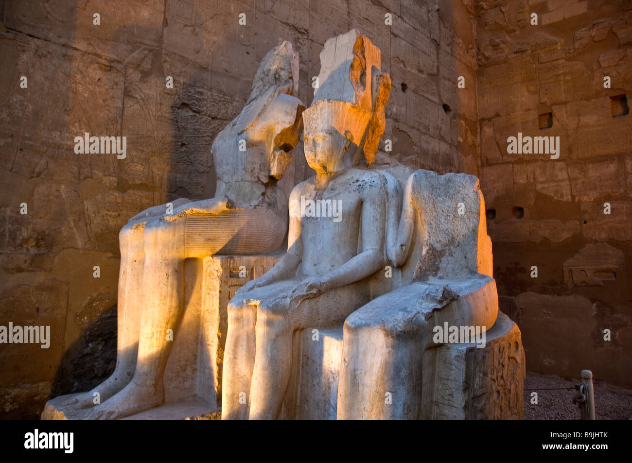 Luxor Temple Egypt night illuminated two defaced statues of royalty
