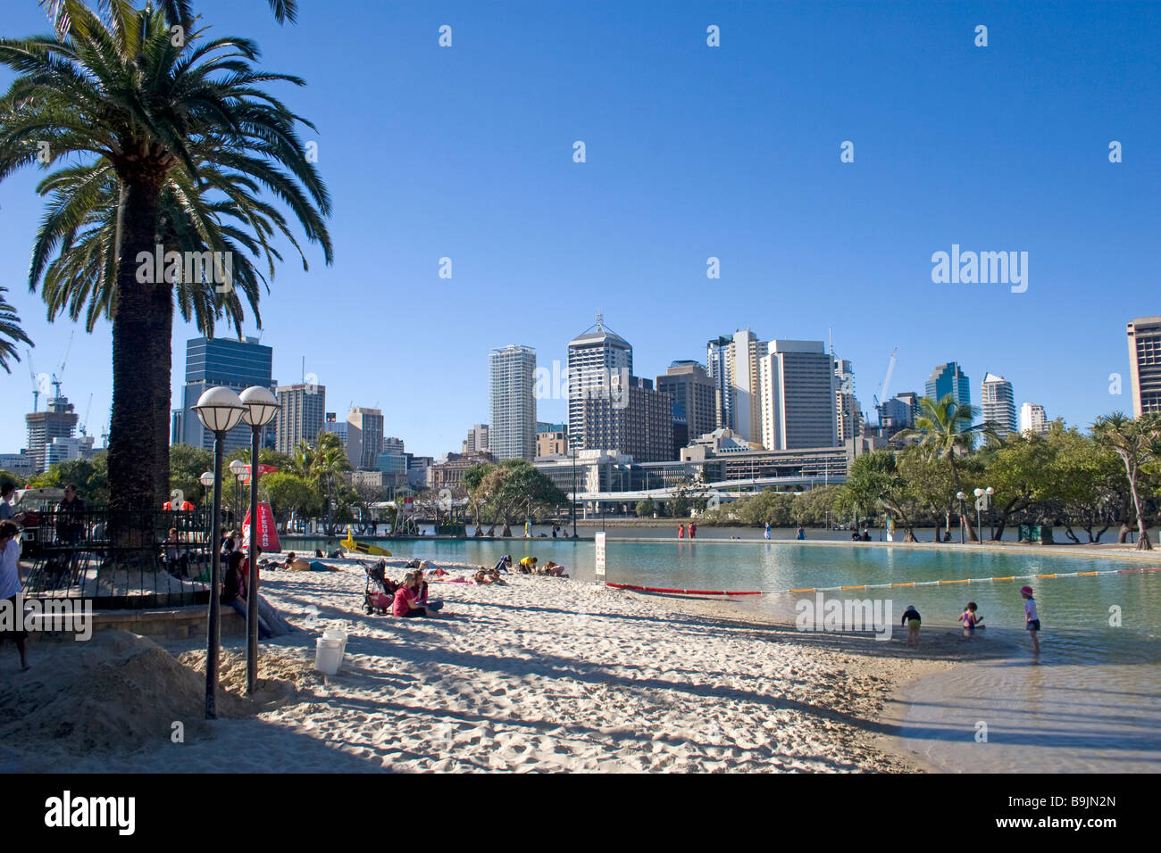 A man made beach in Brisbane has a lookout over the cityscape Stock