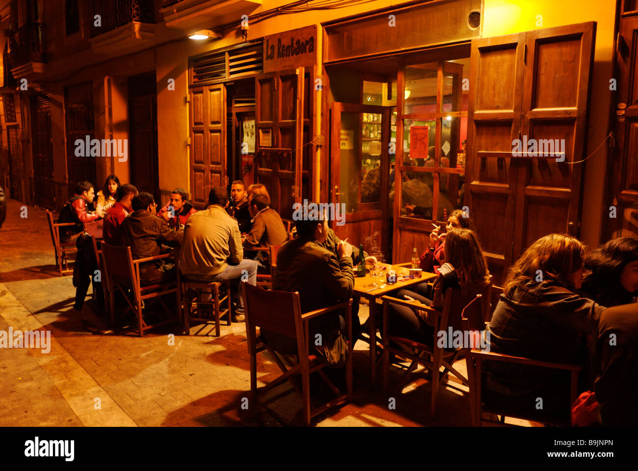 People sitting outside a cafe in El Carmen during las Fallas festival historic city centre of Valencia Spain Stock Photo