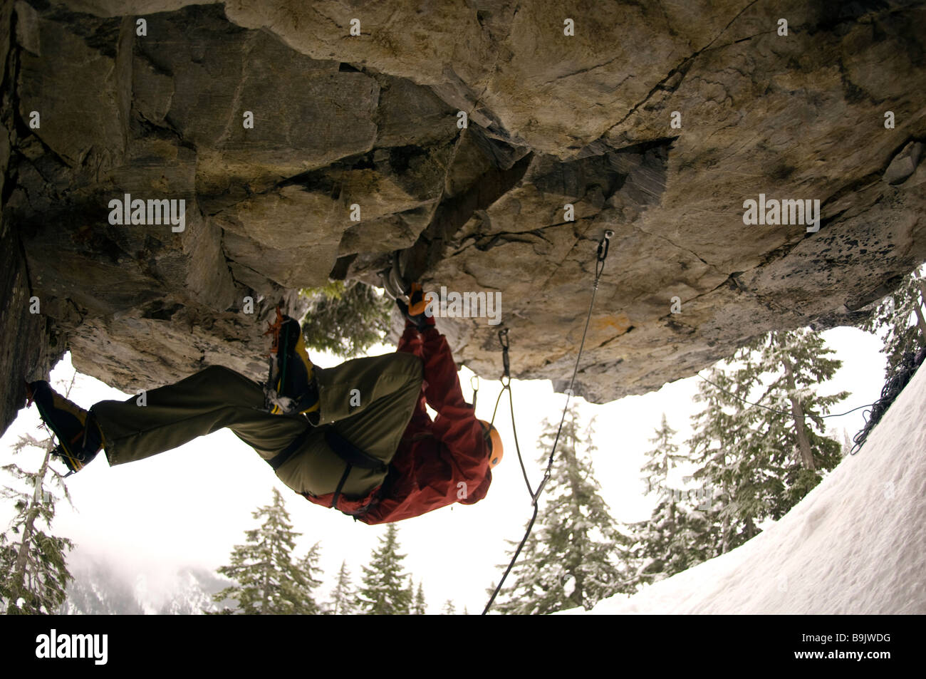 A man in a helmet rock climbing Stock Photo Alamy