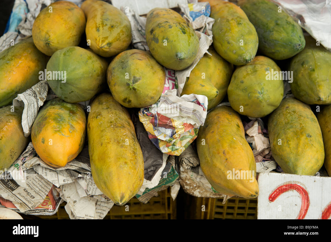 A stack of ripe papayas on a street stall Bangkok Thailand Stock Photo