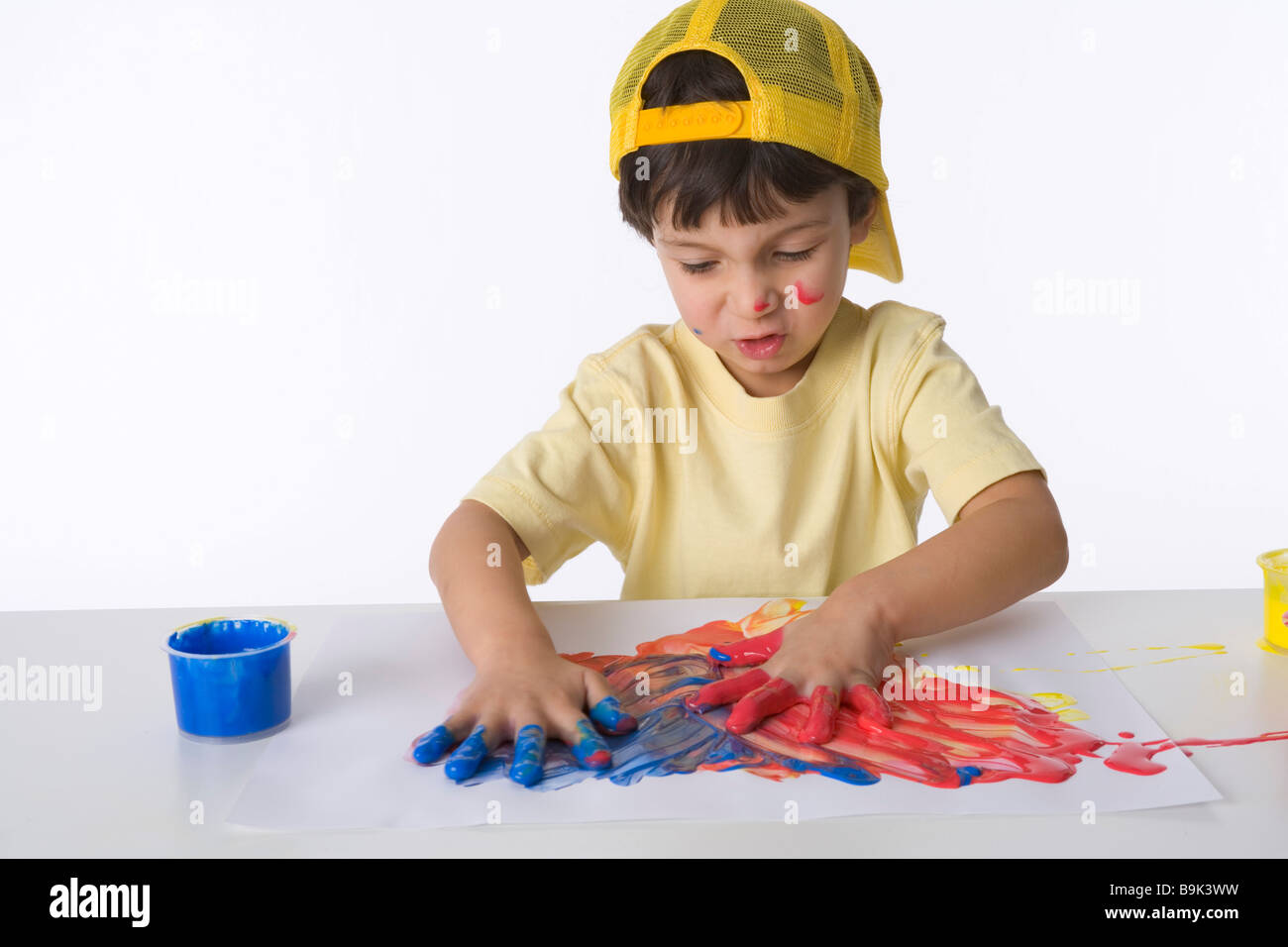 Little boy is making a finger painting Stock Photo