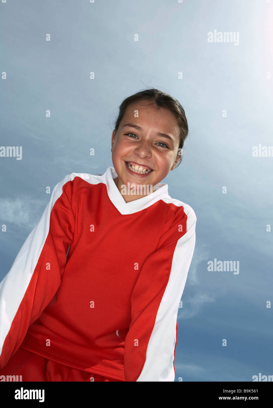Low viewpoint of young female footballer Stock Photo