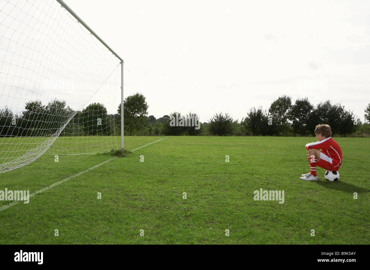 Young footballer looking at goal Stock Photo